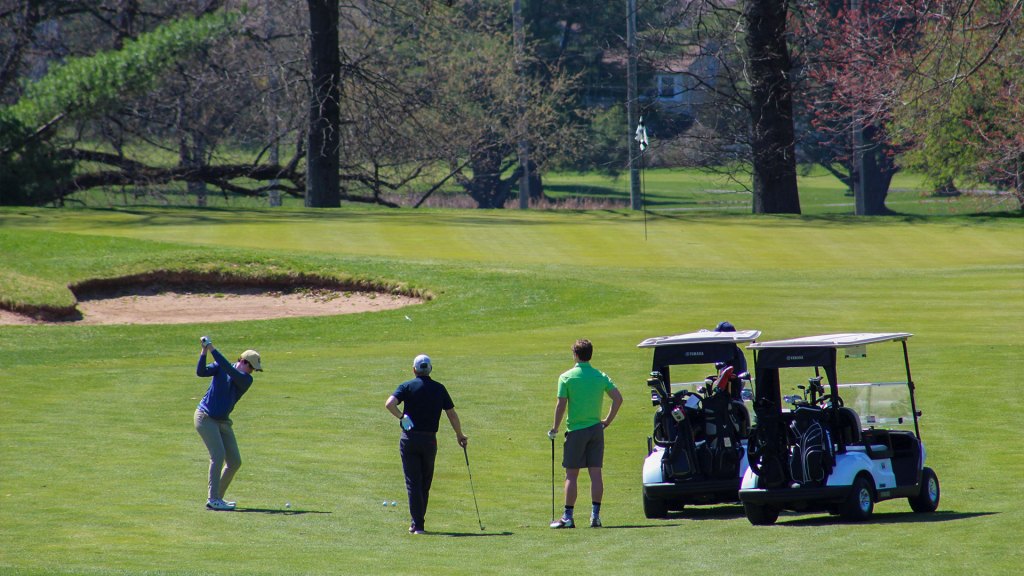 group hitting down the fairway